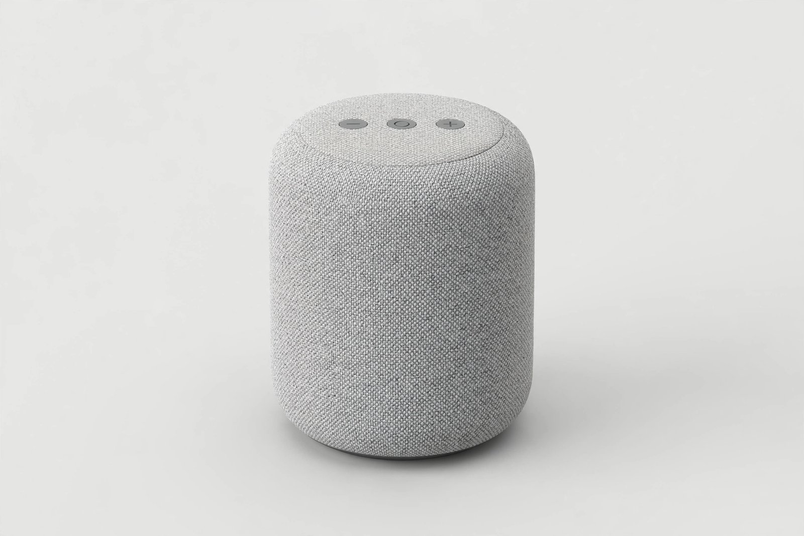Small cylindrical smart speaker with a fabric finish on a plain light background