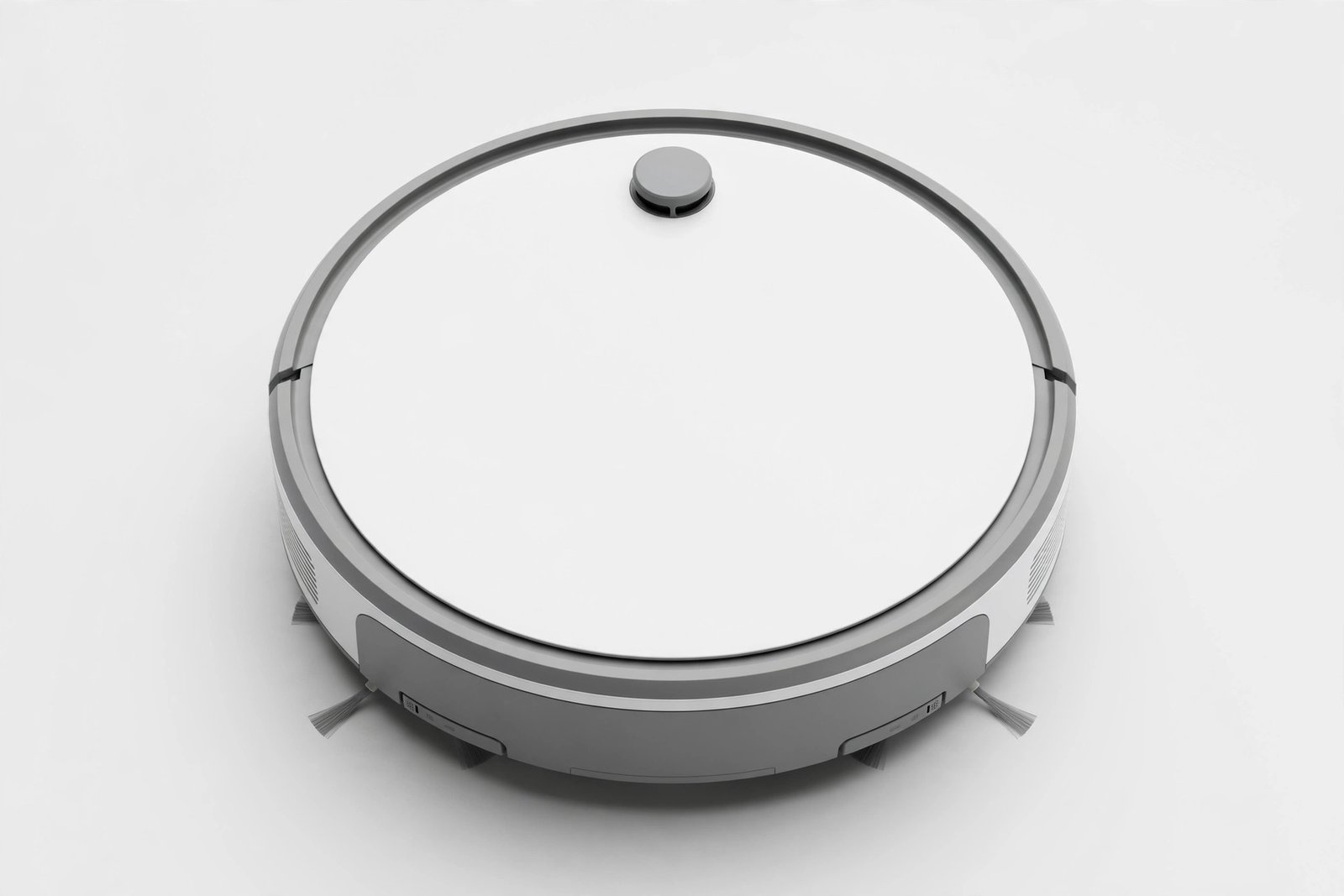 Round low-profile robot vacuum cleaner in white and grey on a light background