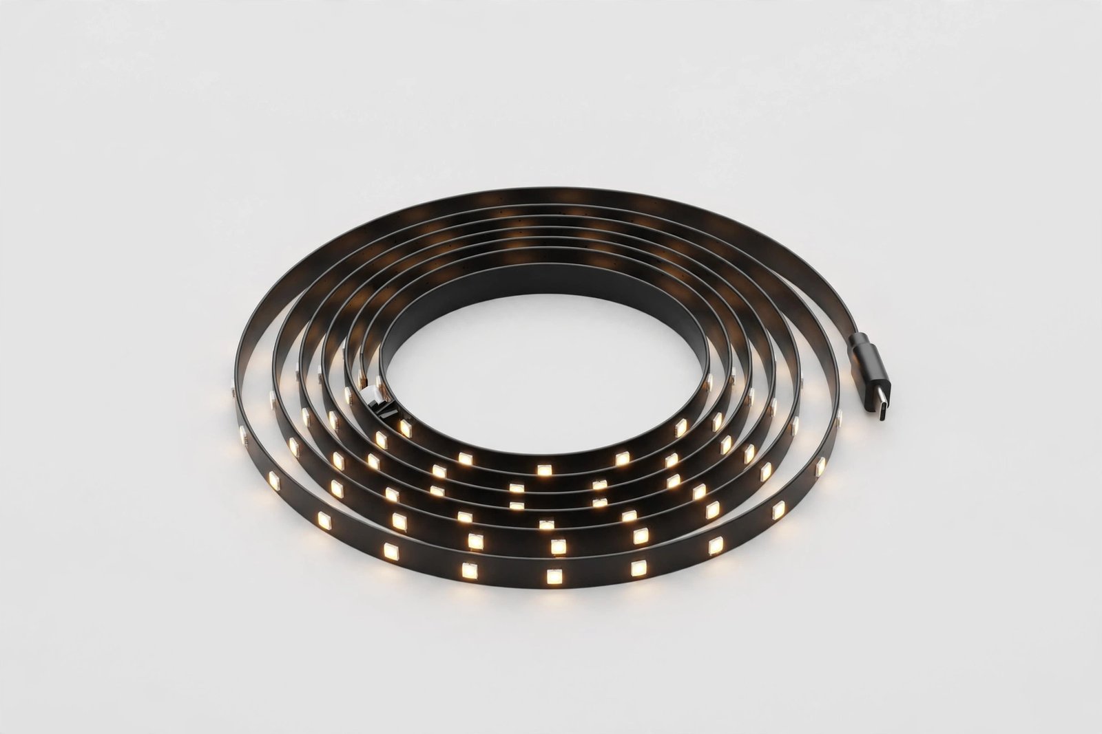 Coiled LED smart light strip on a plain light background