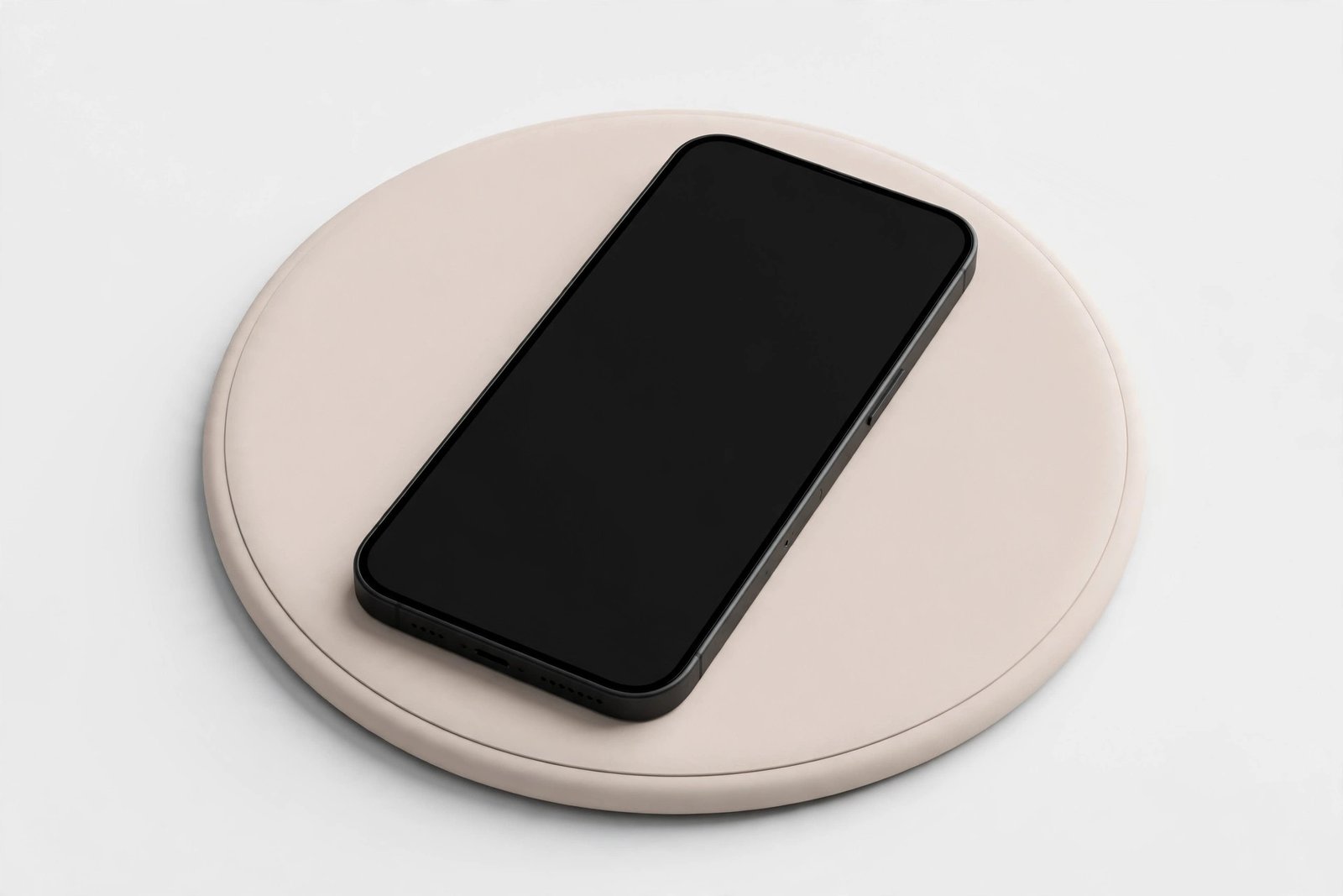 Round wireless charging pad with a smartphone resting on it