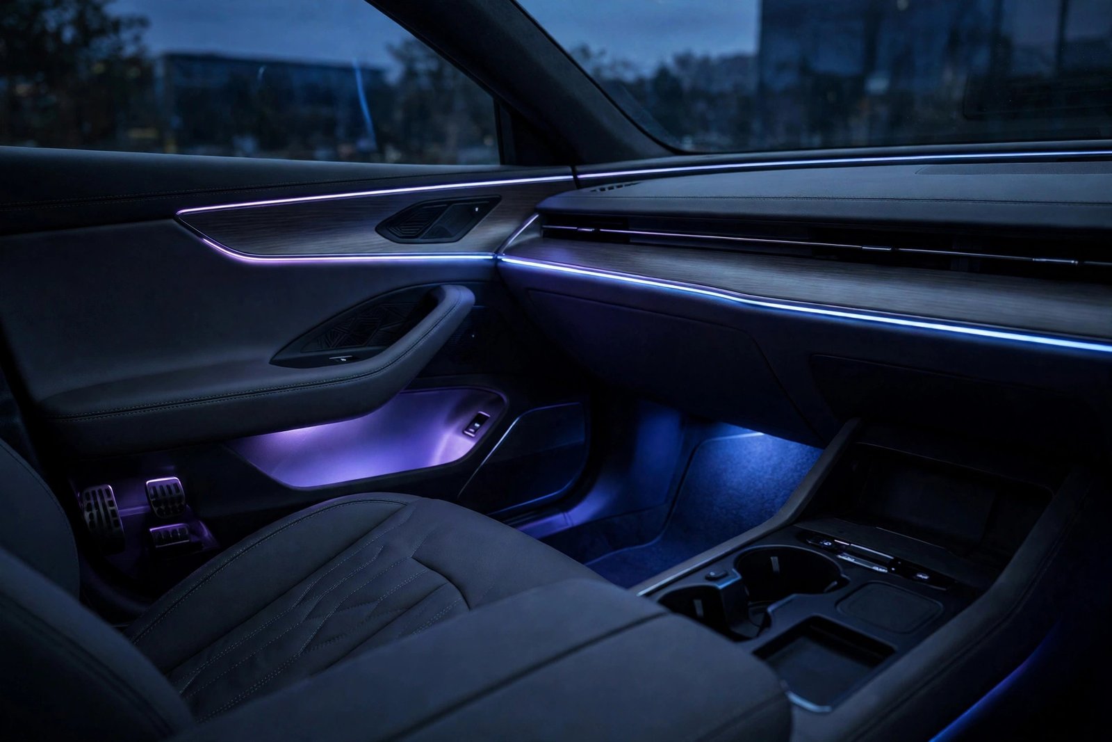 App-controlled LED interior car light strips glowing blue and purple along the footwells and dashboard