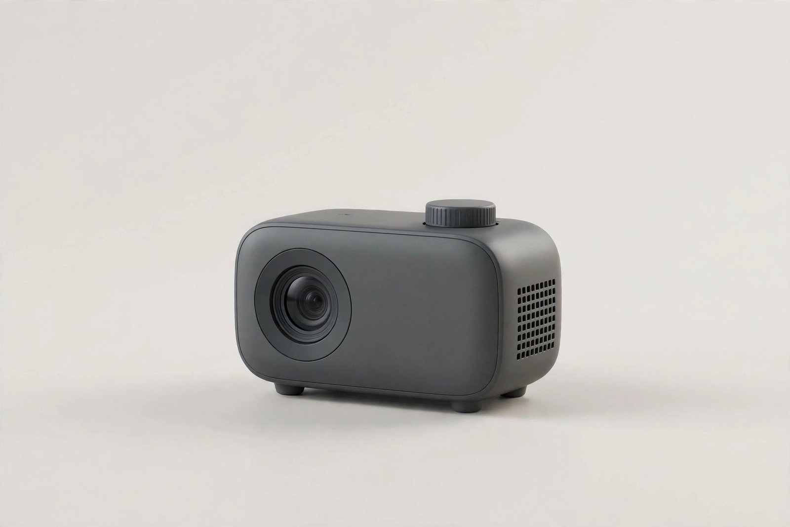 Small portable mini projector on a plain light background