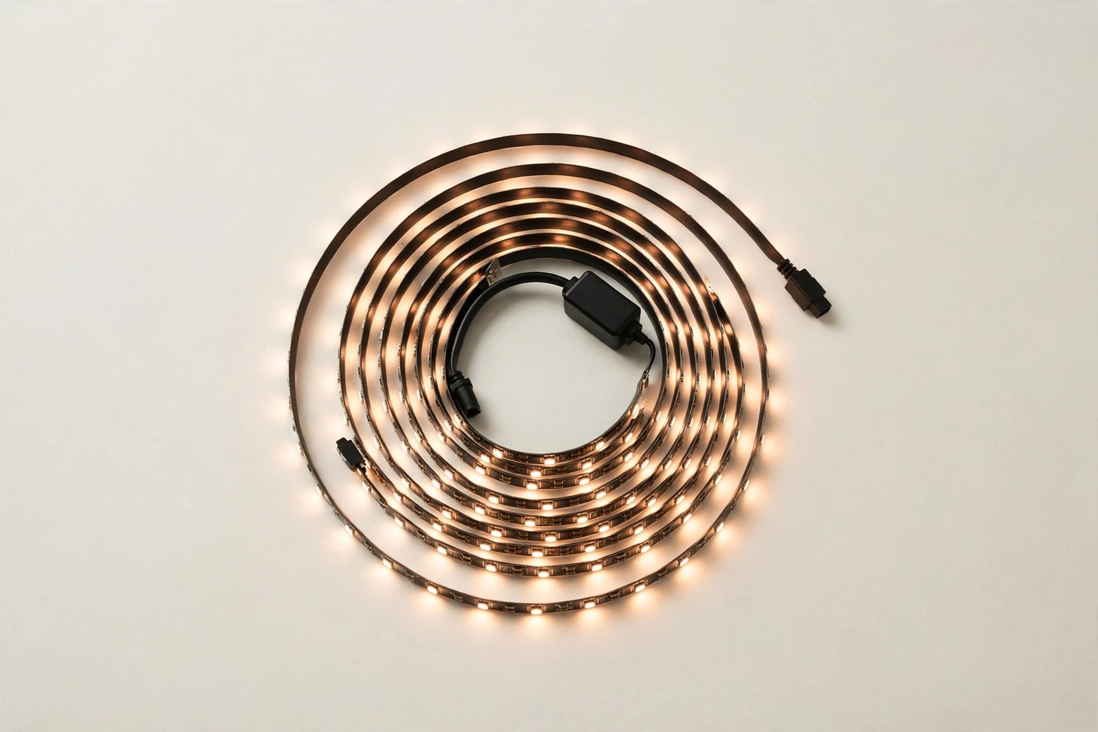 Coiled LED smart light strip on a plain light background